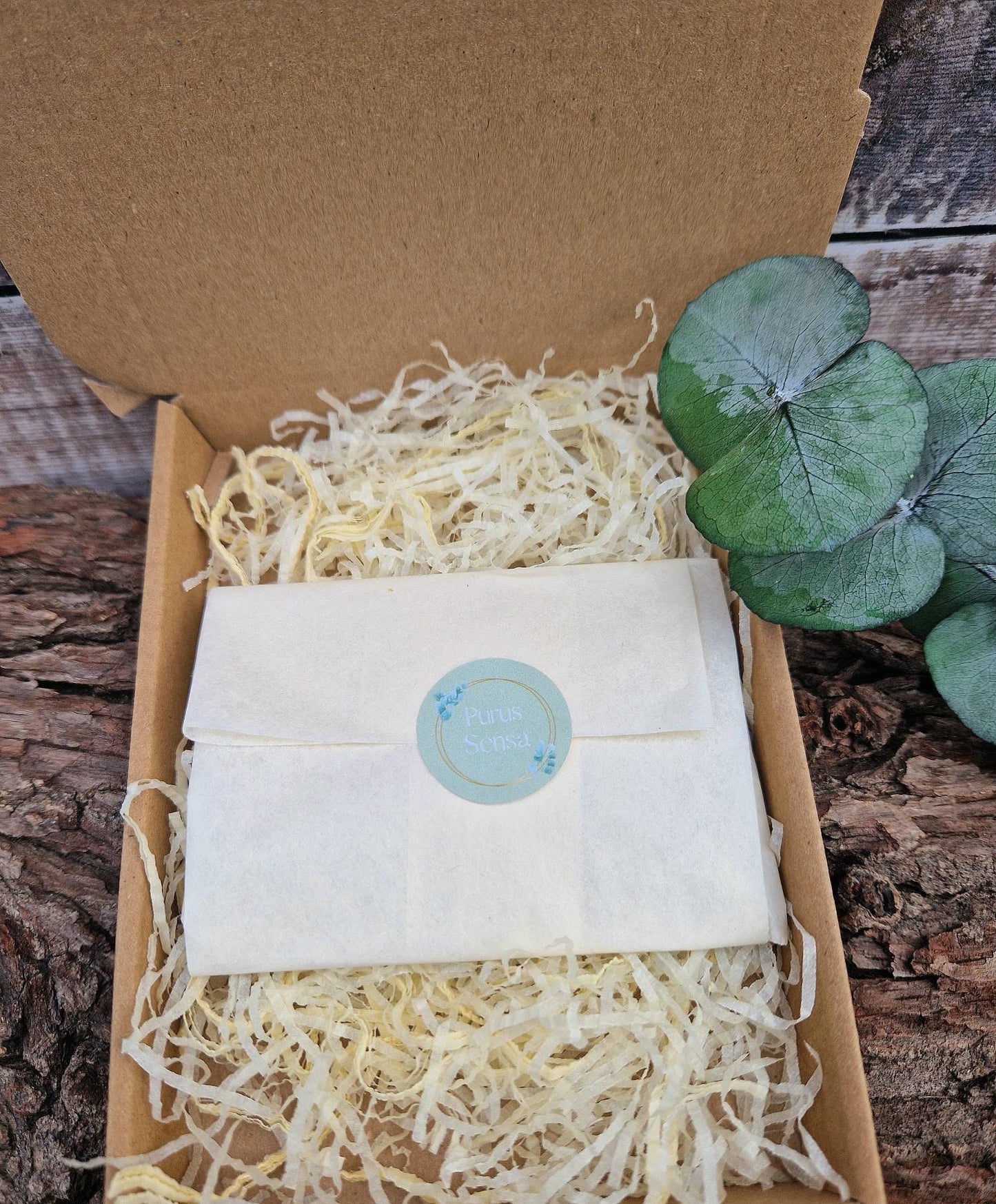 Natural sunstone huggie hoop crystal earrings on a descriptive card.