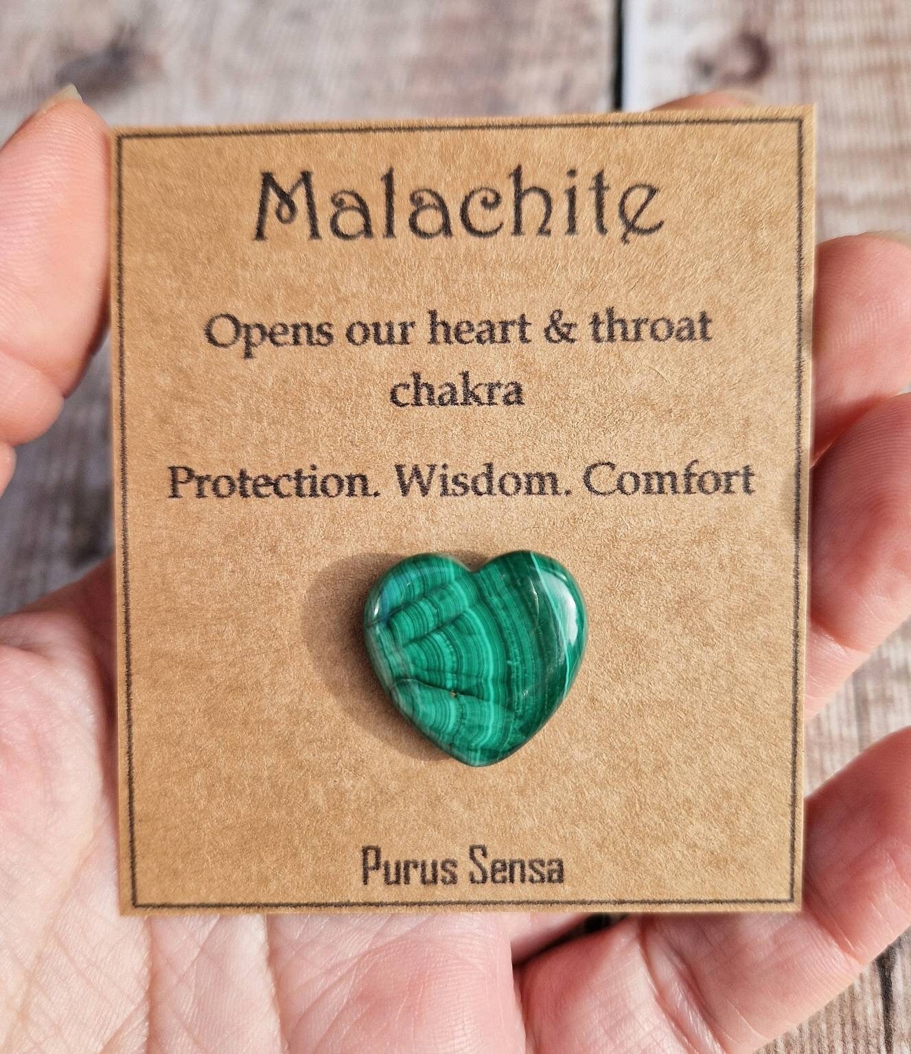 Genuine malachite heart crystal on a descriptive card