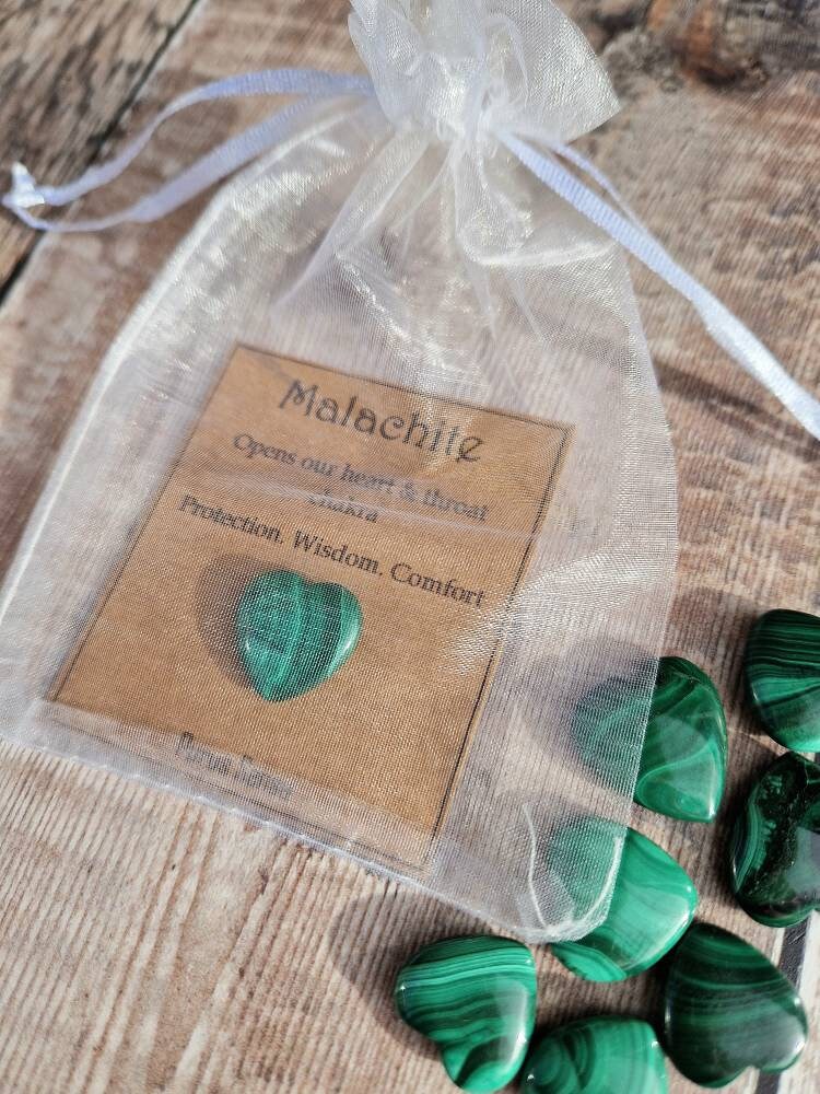 Genuine malachite heart crystal on a descriptive card